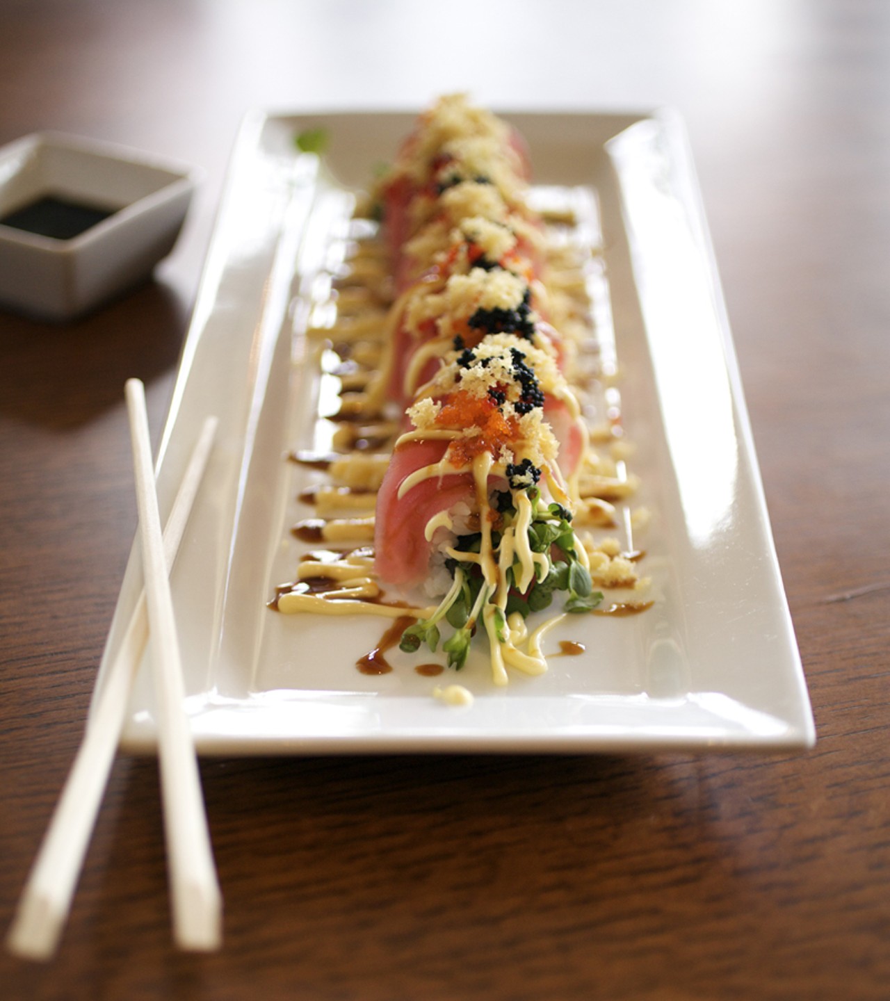 The Red Dragon Roll is a spicy tuna roll topped with tuna, smelt eggs and teriyaki sauce.