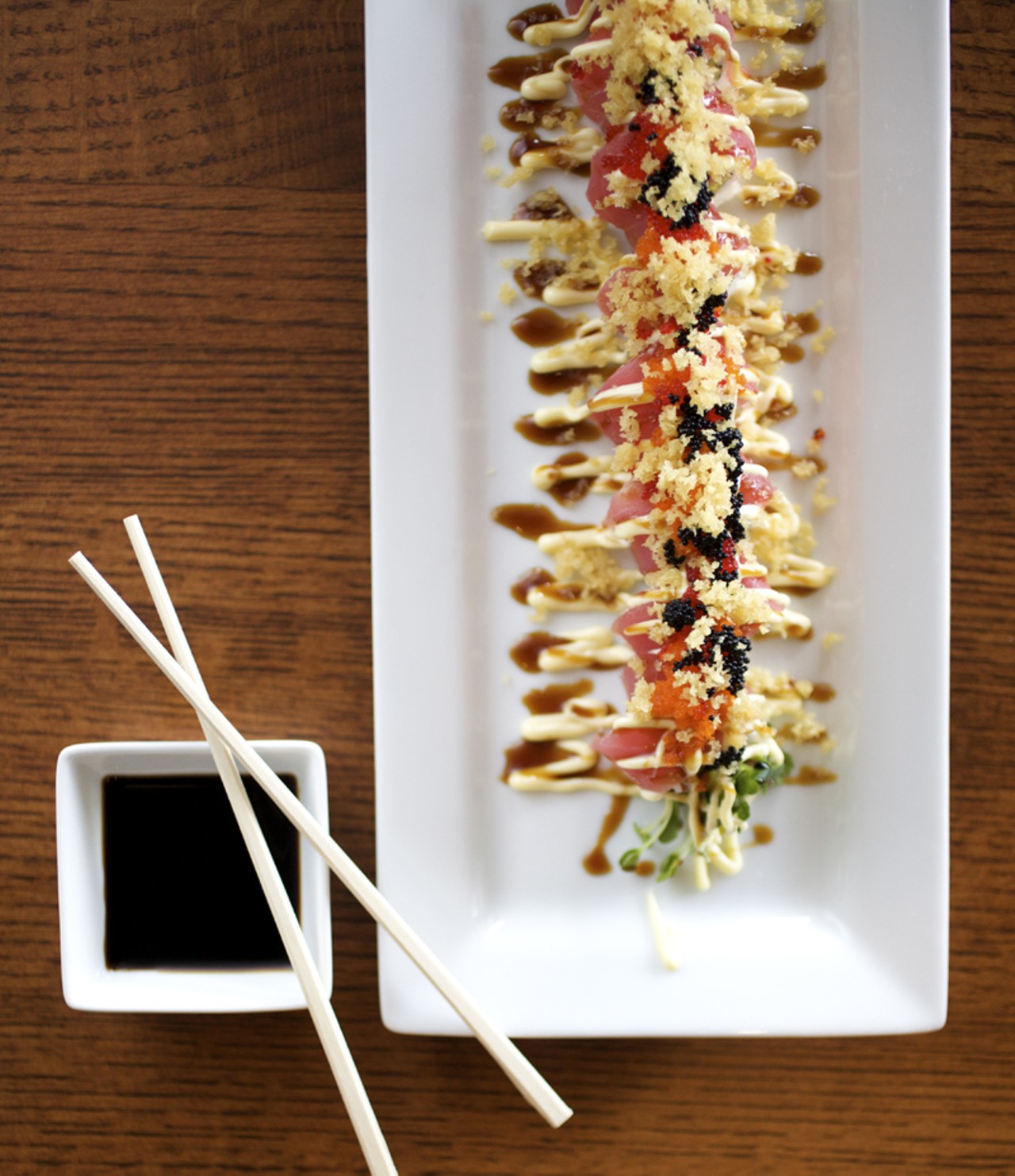 The Red Dragon Roll is a spicy tuna roll topped with tuna, smelt eggs and teriyaki sauce.