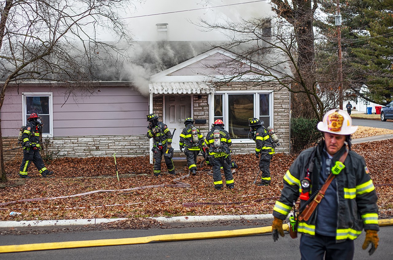 Firefighters prepare to breach a door after extinguishing a fire on Friday, Jan. 26, 2024, in Florissant.