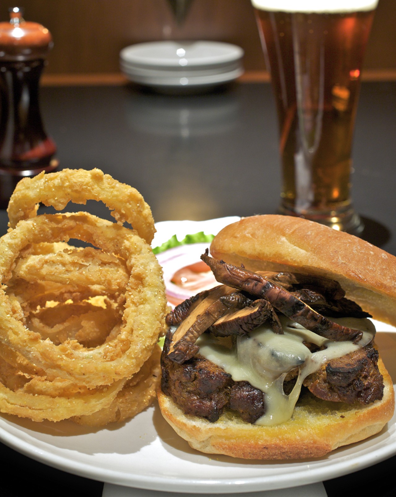 The grilled meatloaf sandwich is served with wild mushrooms, Swiss cheese and chipotle ranch dressing on a ciabatta roll. It is shown here with onion rings.