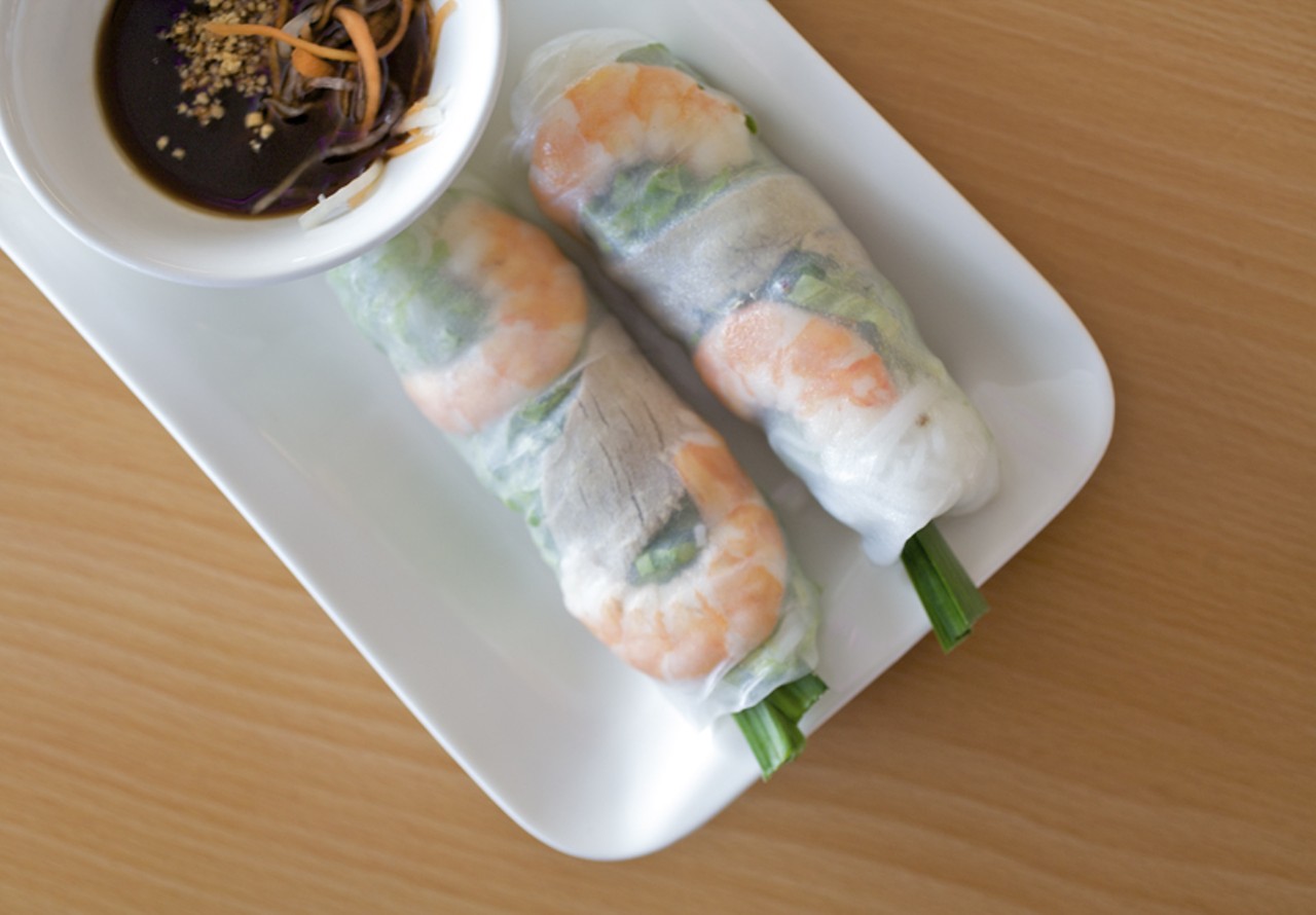 Goi cuon is a spring roll appetizer that's made with shrimp and pork and served with a plum sauce with carrots and peanuts