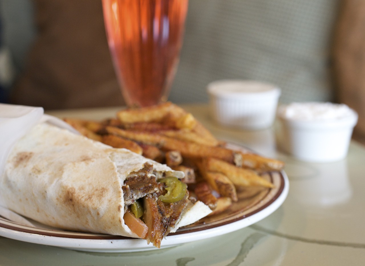 Chicken Shwarma, a Middle Eastern fast-food staple, is a wrap with shaved meat from a spit, in this case, chicken. Served here with the fresh, house made French fries and the rose drink.