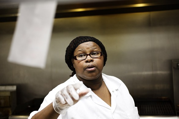 Tracei Dixon, kitchen manager at Flavors BBQ in the Grove, preparing orders in the kitchen.