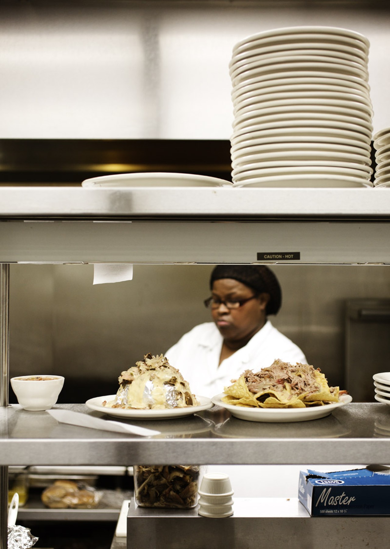 Tracei Dixon, kitchen manager at Flavors BBQ in the Grove, preparing the food.