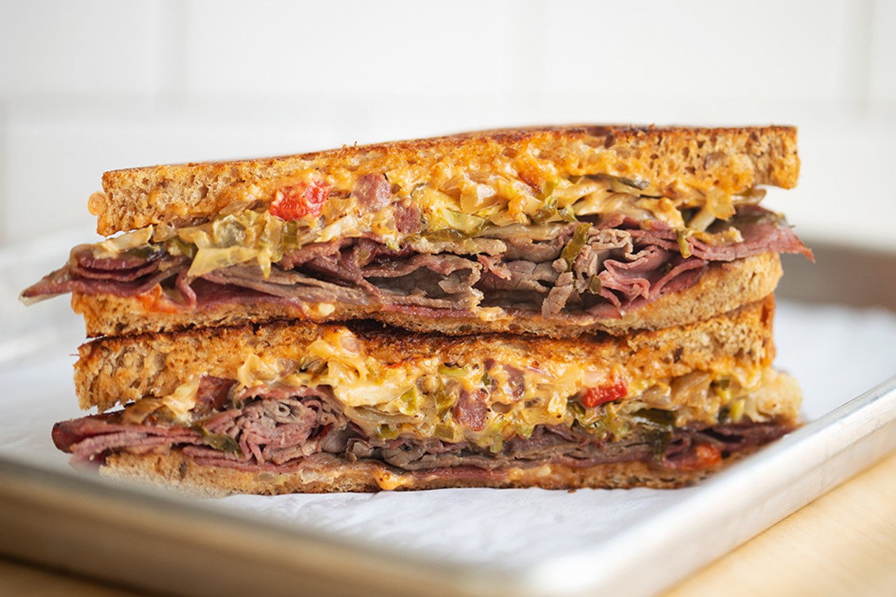 Ruben sandwich with pastrami, braised sauerkraut, fermented brussels sprouts, thousand island dressing and swiss cheese on Companion Bakery rye bread.