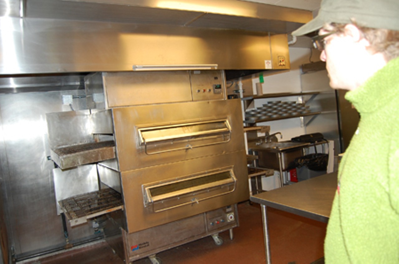 Chris Sommers, the owner of Pi, 6144 Delmar Boulevard, describes the conveyor-belt oven oven used to make deep dish pizzas.