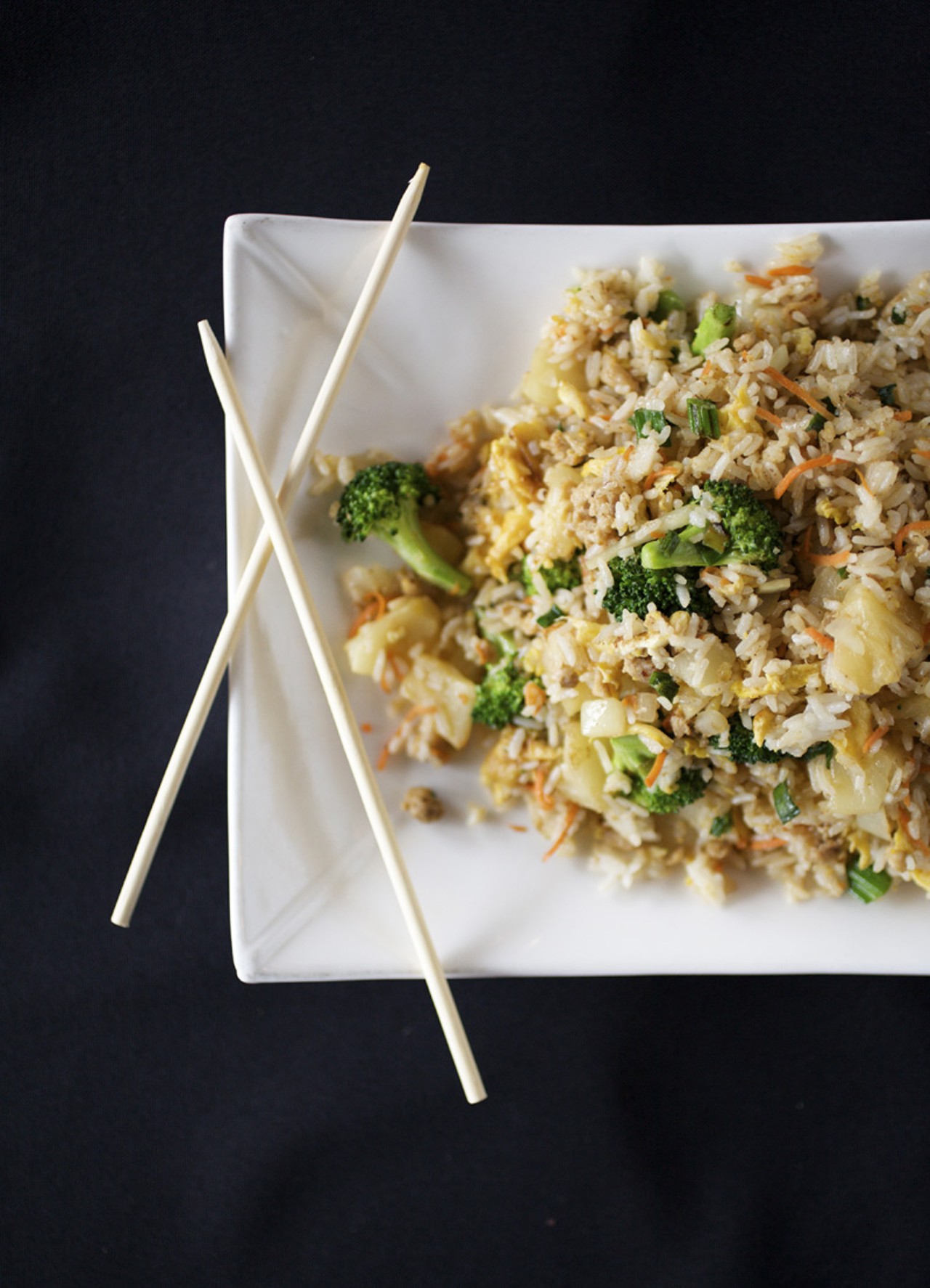Pineapple Fried Rice is prepared with stir-fried eggs, pineapple, scallions, curry sauce and onions. It is served with your choice of beef, chicken or shrimp.