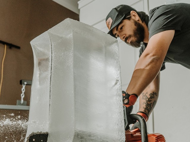 Jordan Goodman cuts a block of ice for Good Ice.