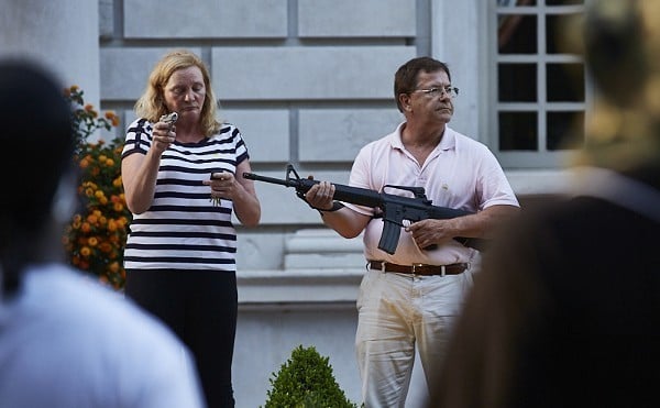Mark and Patricia McCloskey hold guns outside their home.
