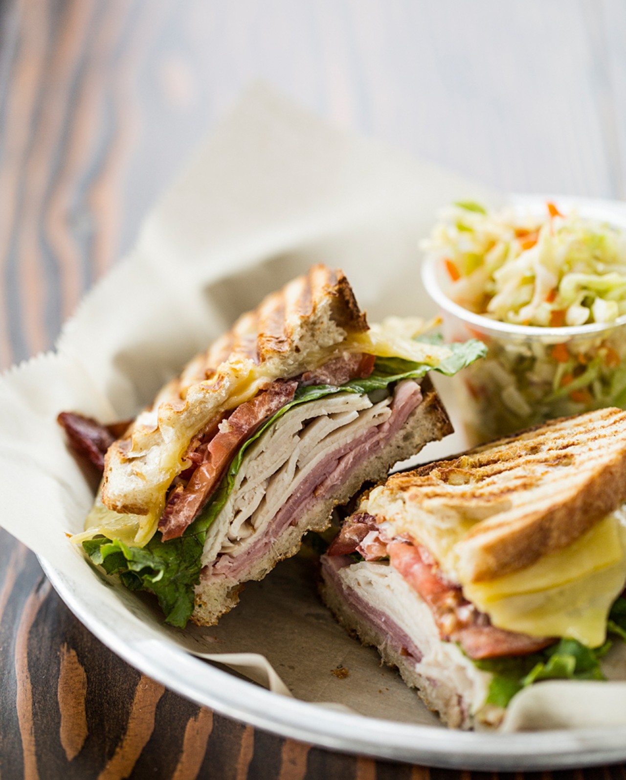 The club sandwich is made with turkey, ham, bacon, lettuce, tomato, cheese and aioli.