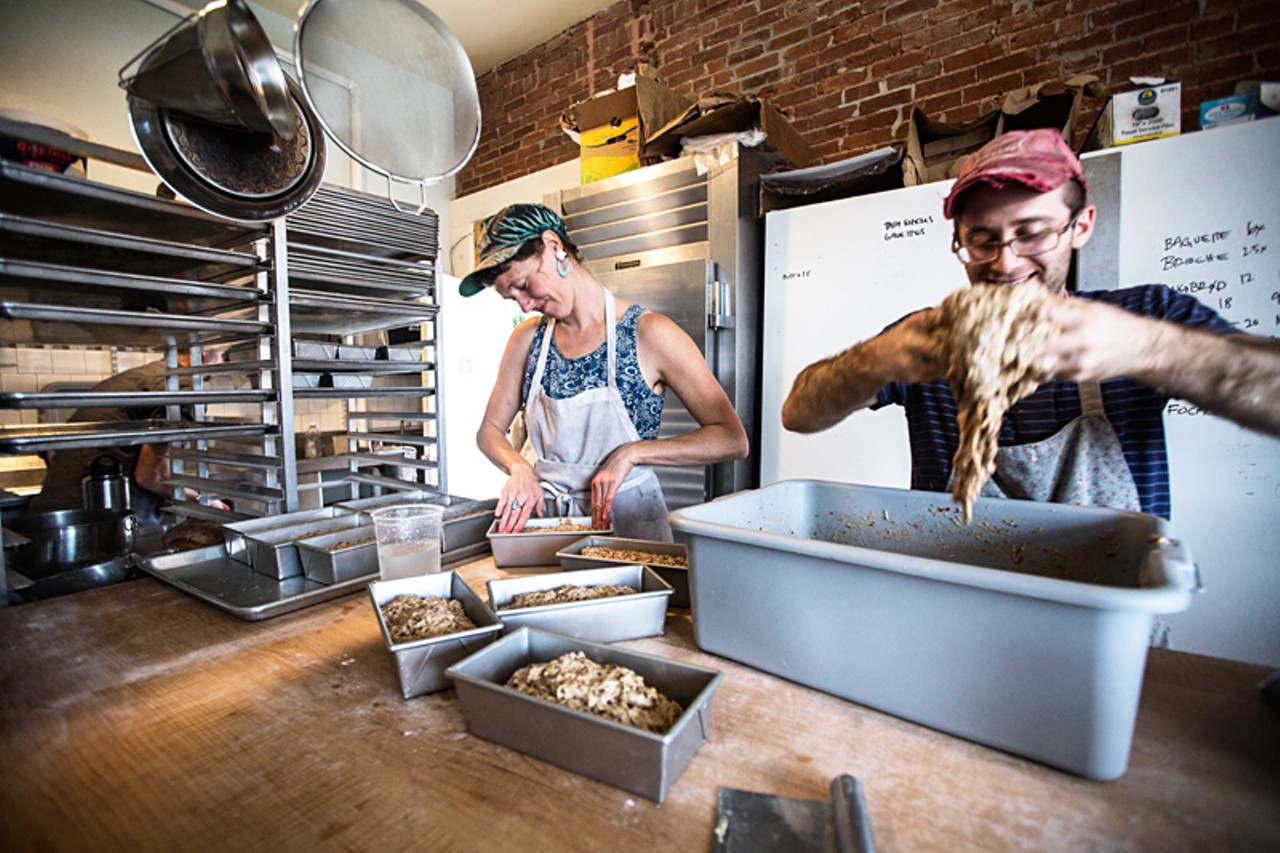Jenny Wilson and Jake Marks of Red Fox Baking prepare Rugbr&oslash;d (a Danish bread) in the Grove East kitchen.
