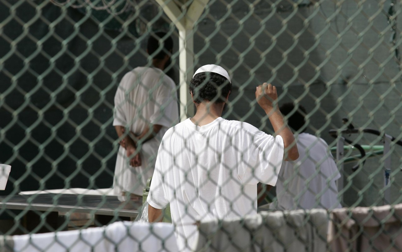Detainees talk inside Camp 4. White clothing is given to only the best-behaved ones.