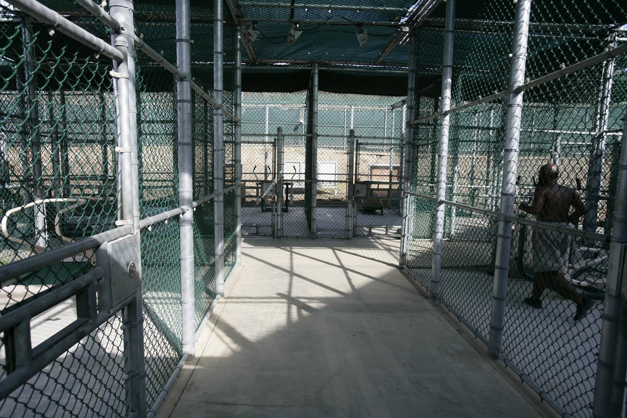 A detainee (right) exercises in Camp 5&rsquo;s rec yards. Inmates get at least two hours a day outside, playing soccer or running in 10-by-20-foot cages.