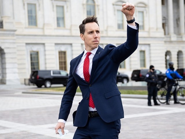 Sen. Josh Hawley (R-Mo.) gesturing toward a crowd of supporters of President Donald Trump gathered outside the U.S. Capitol to protest the certification of President-elect Joe Biden's electoral college victory on Jan. 6, 2021. Some demonstrators later breached and stormed the Capitol.