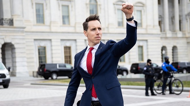 Sen. Josh Hawley (R-Mo.) gesturing toward a crowd of supporters of President Donald Trump gathered outside the U.S. Capitol to protest the certification of President-elect Joe Biden's electoral college victory on Jan. 6, 2021. Some demonstrators later breached and stormed the Capitol.