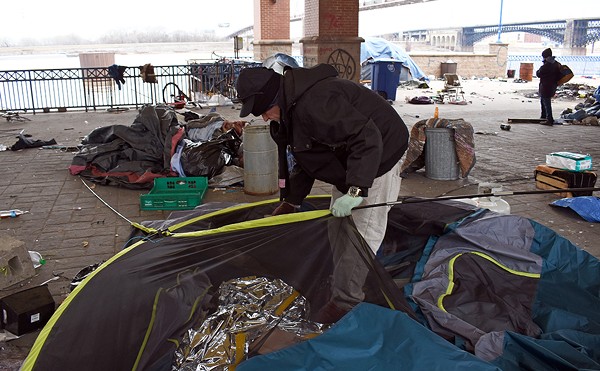 James, who declined to give his last name, disassembles his tent as the city evicted an encampment of people experiencing homelessness near Laclede's Landing on March 10.