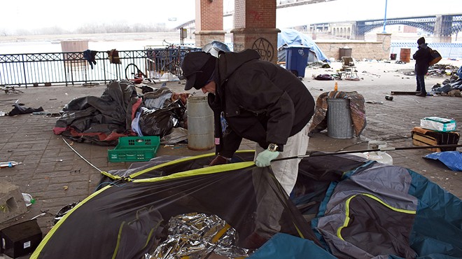 James, who declined to give his last name, disassembles his tent as the city evicted an encampment of people experiencing homelessness near Laclede's Landing on March 10.