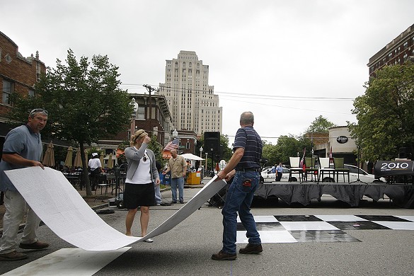 Craig Miller and Ed Rhomberg piece together the oversized, 32 x 32-foot chess board on Maryland Avenue before the game begins. The game of "human chess" was hosted by the Chess Club and Scholastic Center of Saint Louis (CCSCSL) for the upcoming final rounds of the national Chess Championships held in St. Louis May 22-25.
