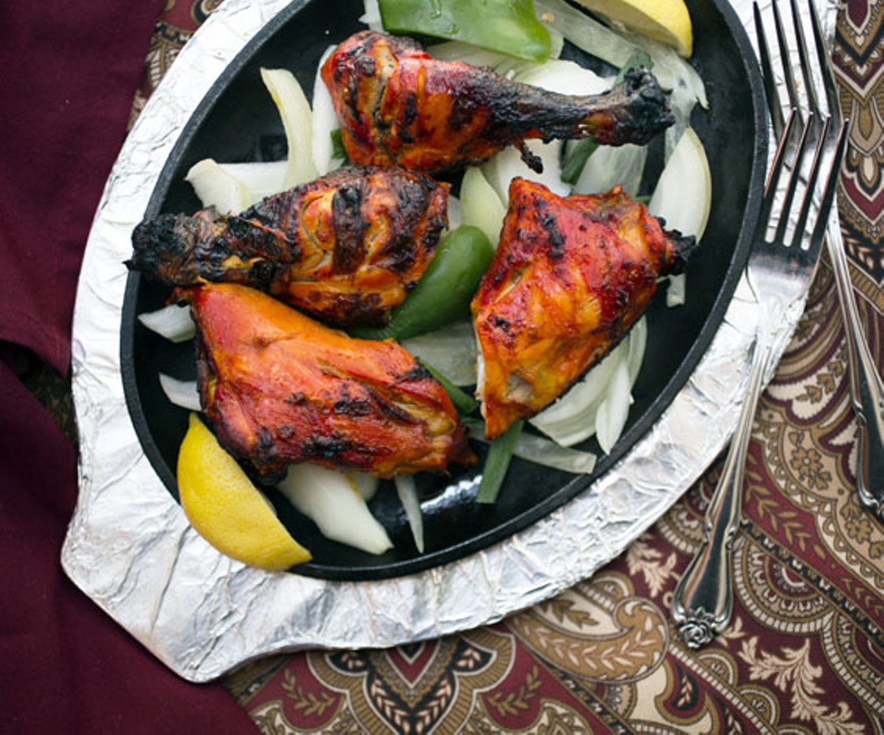 With the tandoori chicken, the poultry is marinated in yogurt and spices, then broiled over mesquite in a tandoor oven.