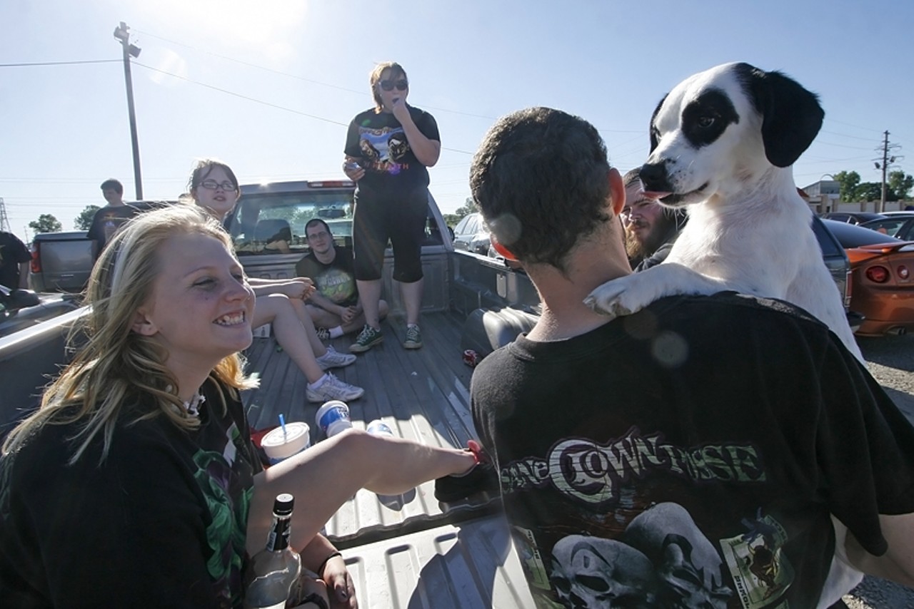 Sarah smiles as Rob, right, lifts up his dog Maggie. This is Sarah's first ICP concert.
