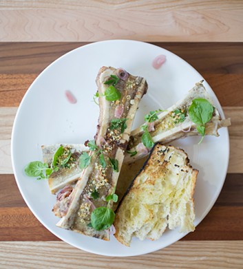 Decadent bone marrow with grilled bread, watercress and shallots.