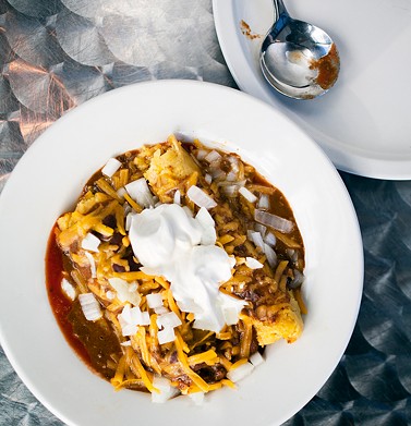Joe's chili can come spooned over two tamales with special sauce, cheese, onions and sour cream.