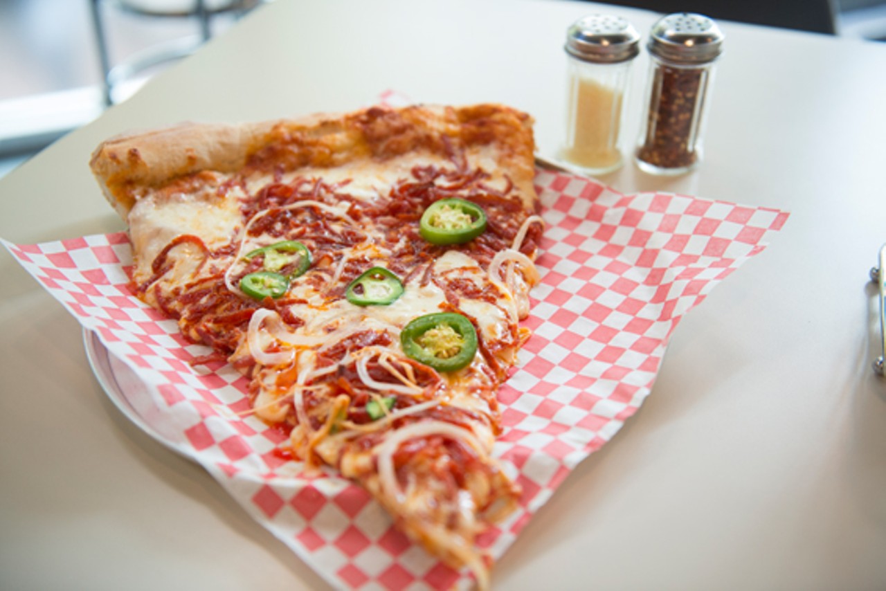 This slice from a 30-inch pizza features pepperoni, fresh jalape&ntilde;os and onions.