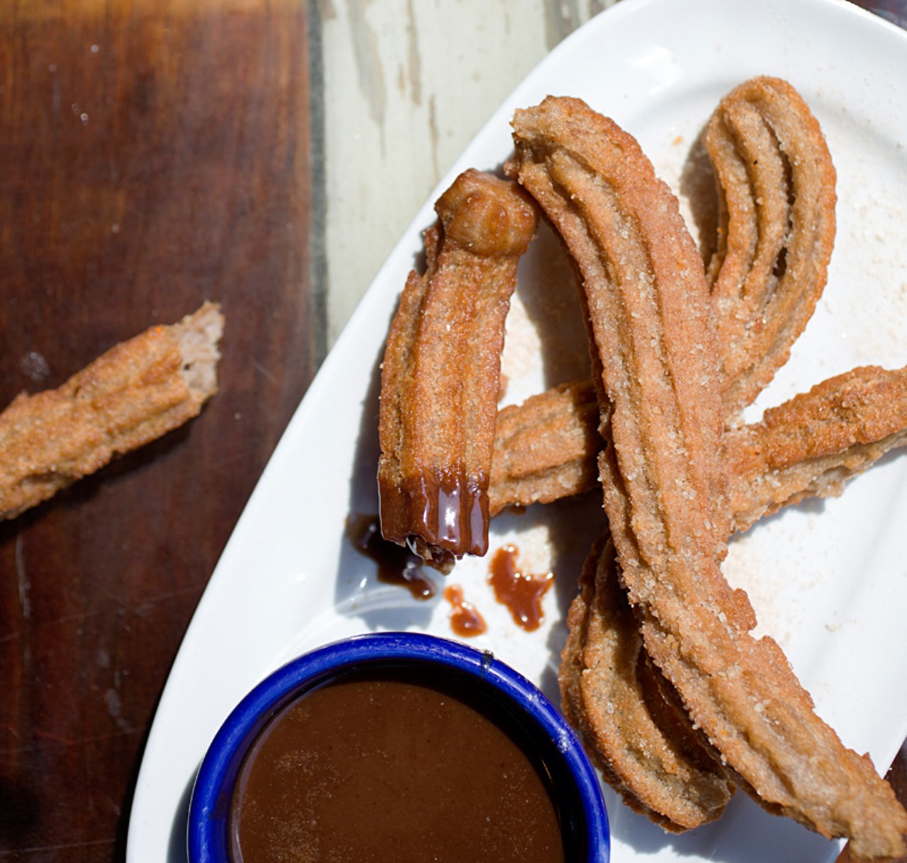 Churros, coated with cinnamon, are made in-house and served with Mexican chocolate sauce.