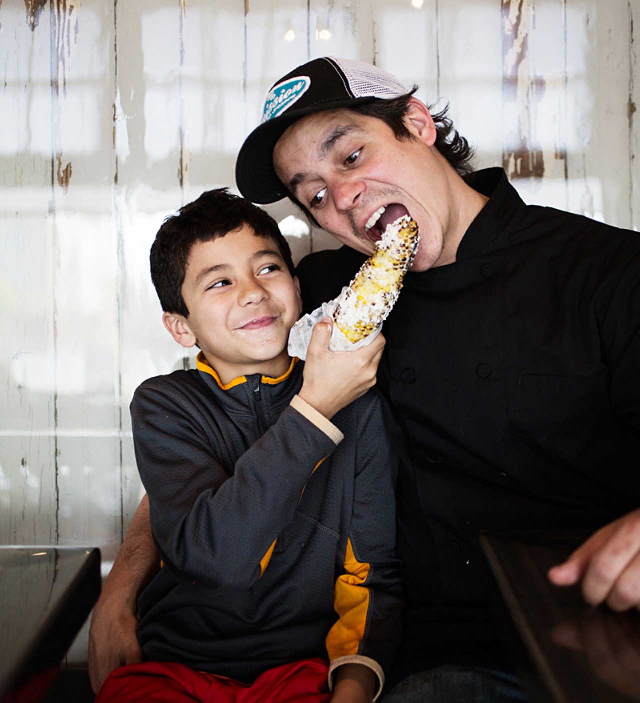 Owner and chef Jason Tilford's ten-year-old son, Julian, eating some roasted street corn.