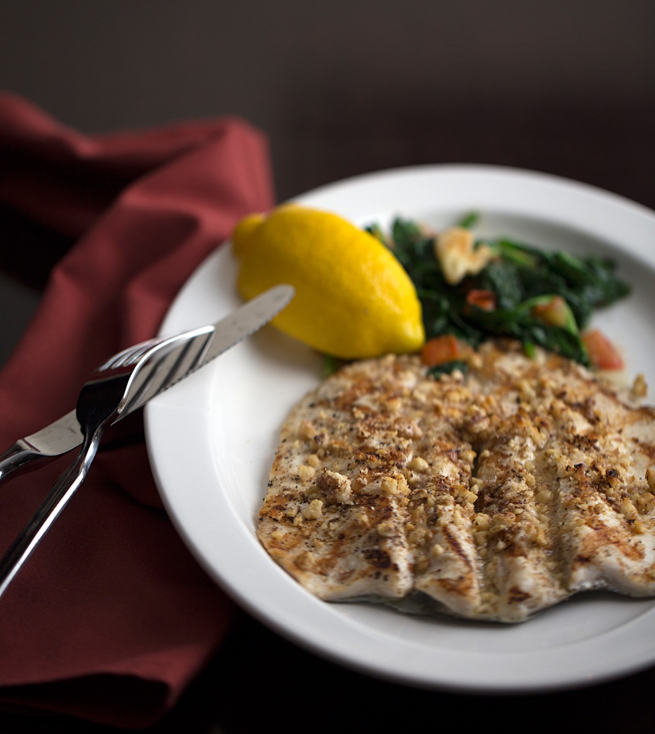 Walnut-encrusted trout with lemon butter and spinach.