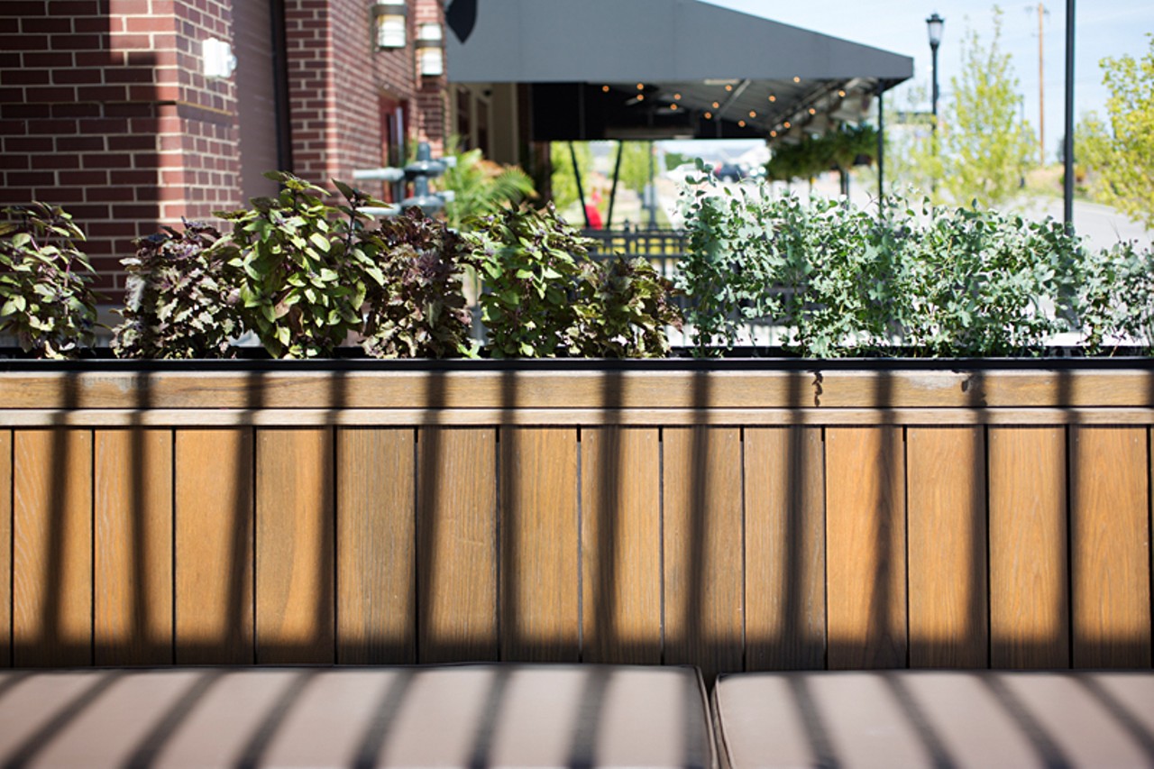 Herbs surround the outdoor patio dining area.