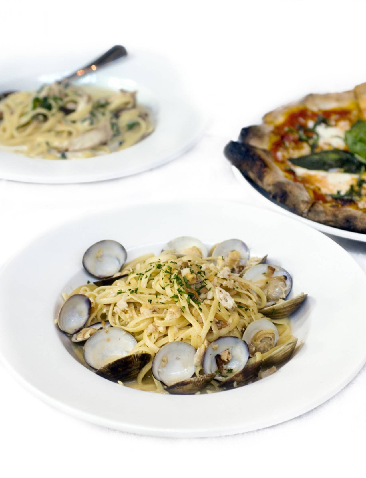 The linguini with white clam sauce is shown here with the fettuccine Romano and Margherita Pizza. The fettuccini is made with grilled chicken, prosciutto, spinach and cream sauce. The pizza is Racanelli&rsquo;s tribute to the original Italian pizza, made with Roma tomatoes, fresh mozzarella, fresh basil and Parmesan cheese.