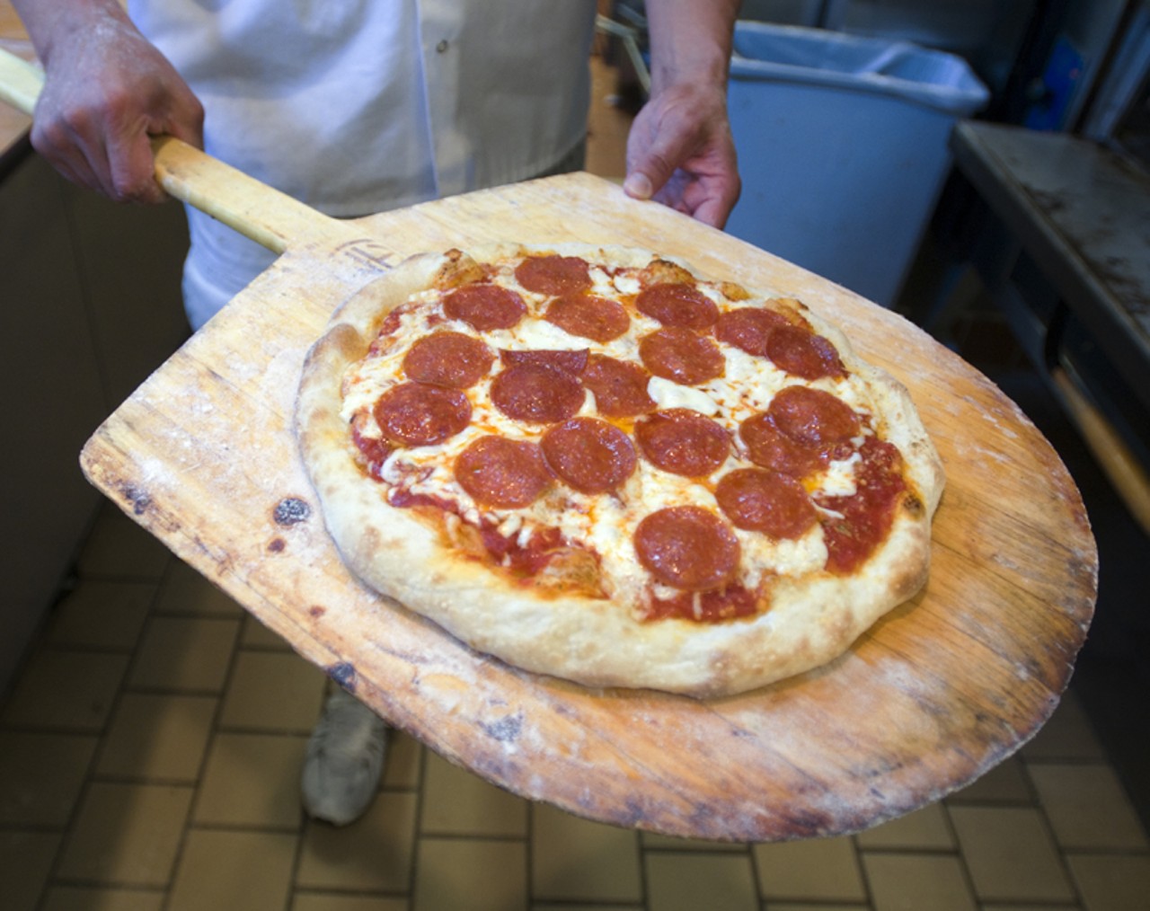 A pepperoni pizza has a rustic appeal. The dough is made from scratch at the restaurant.