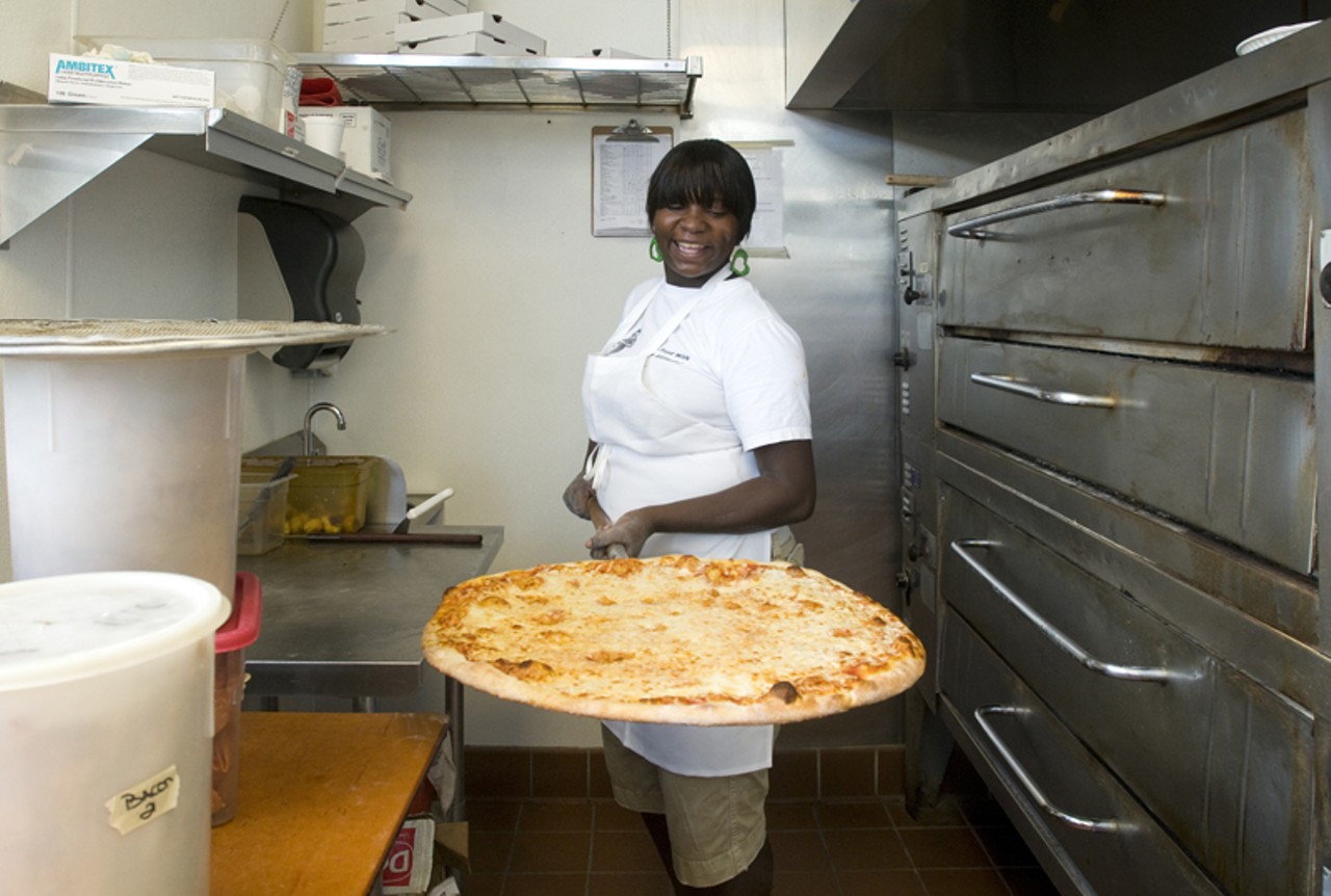 At the front of the restaurant, through a separate entrance, is Racanelli&rsquo;s Express, where you can still walk up to the counter and order a slice to go. Crystal Salone is shown here with a rather large pie. She guessed it was somewhere between 20 and 22 inches. Impressive.
