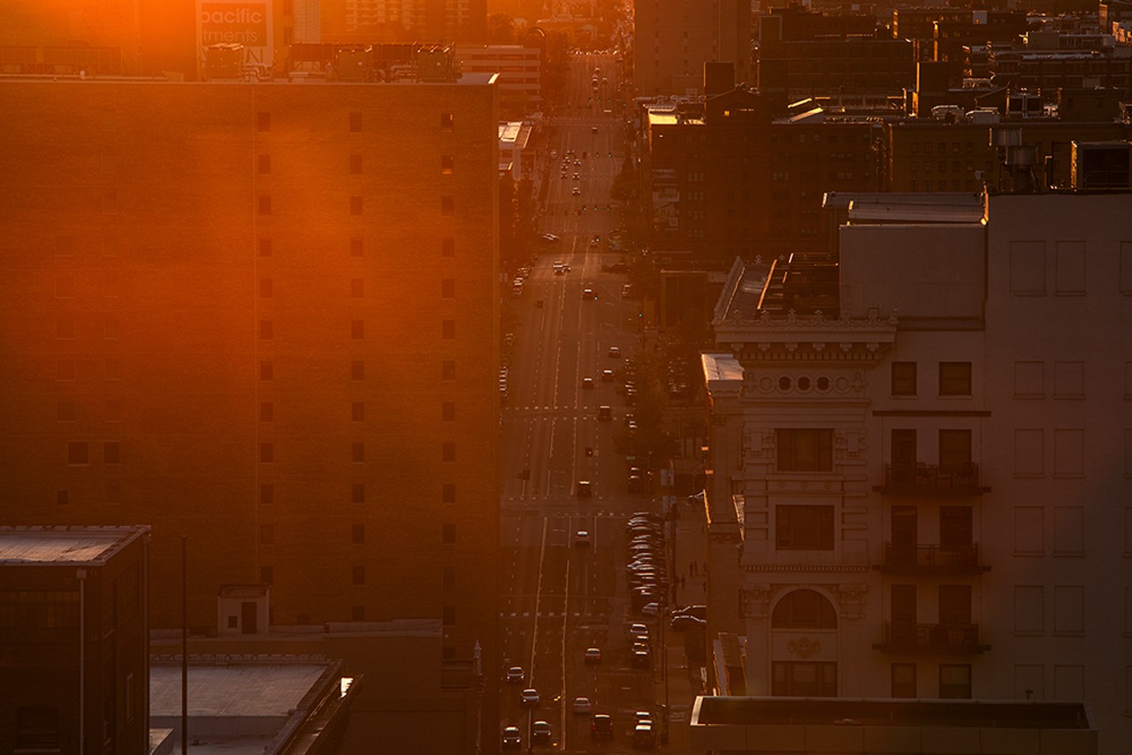 Sunlight streams down on traffic on Olive Street as viewed from the Railway Exchange building.