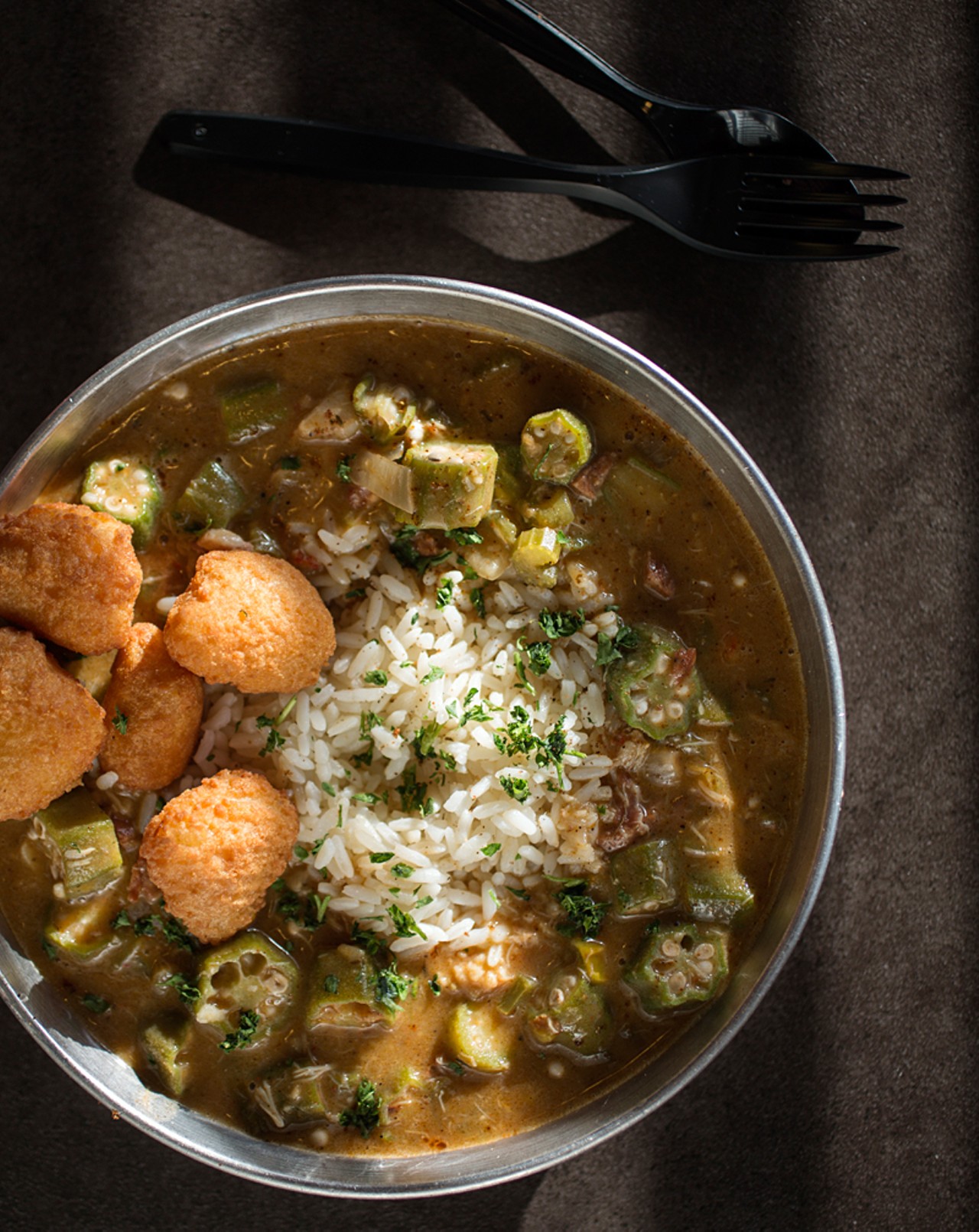 Seafood gumbo - that's chorizo, andouille, crab, crawfish, shrimp, onions, peppers, celery, okra - comes served with rice.