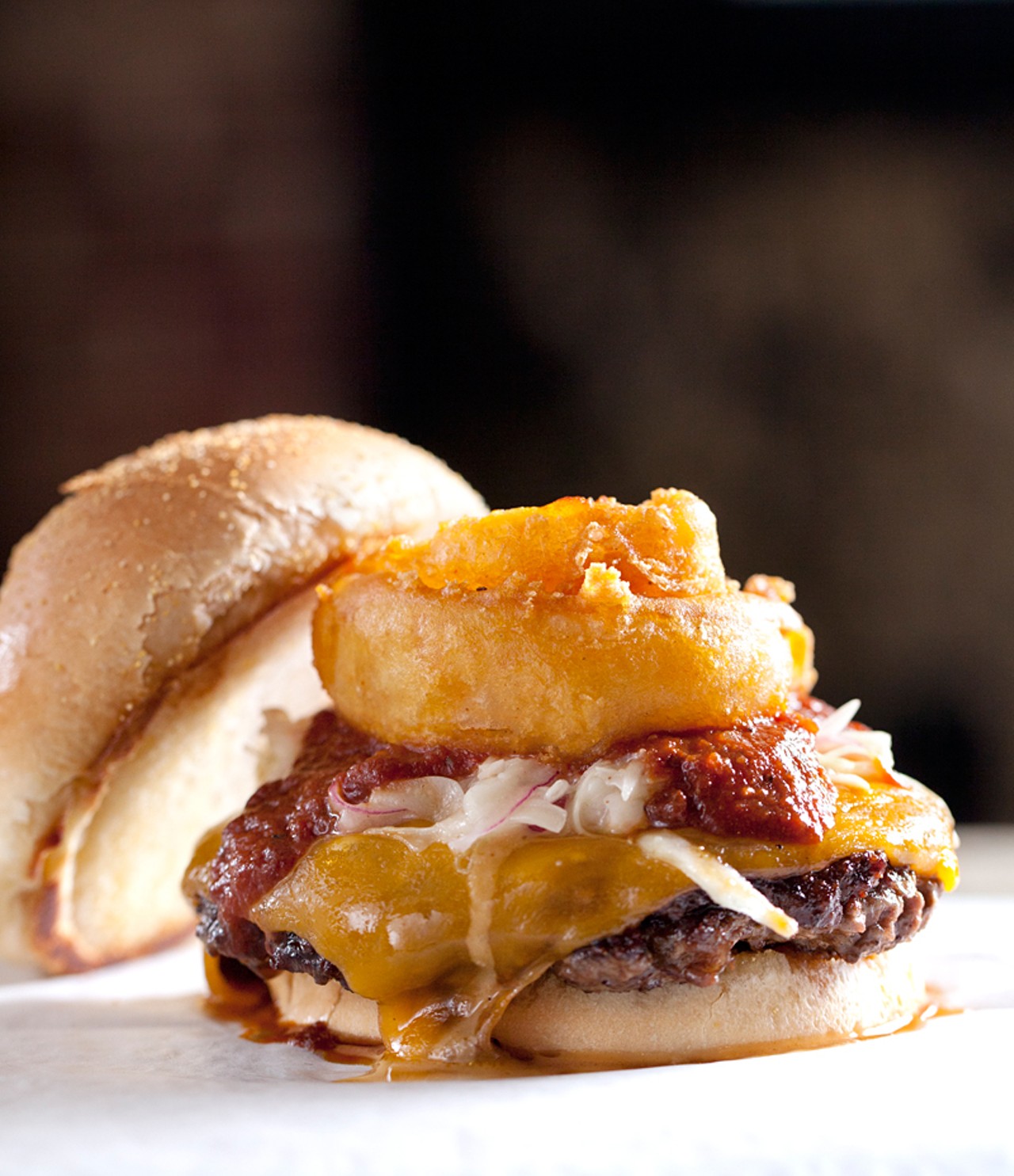 The "Smokehouse Smash Burger" is served with bbq, bacon jam, onion ring, carolina slaw and cheddar cheese.