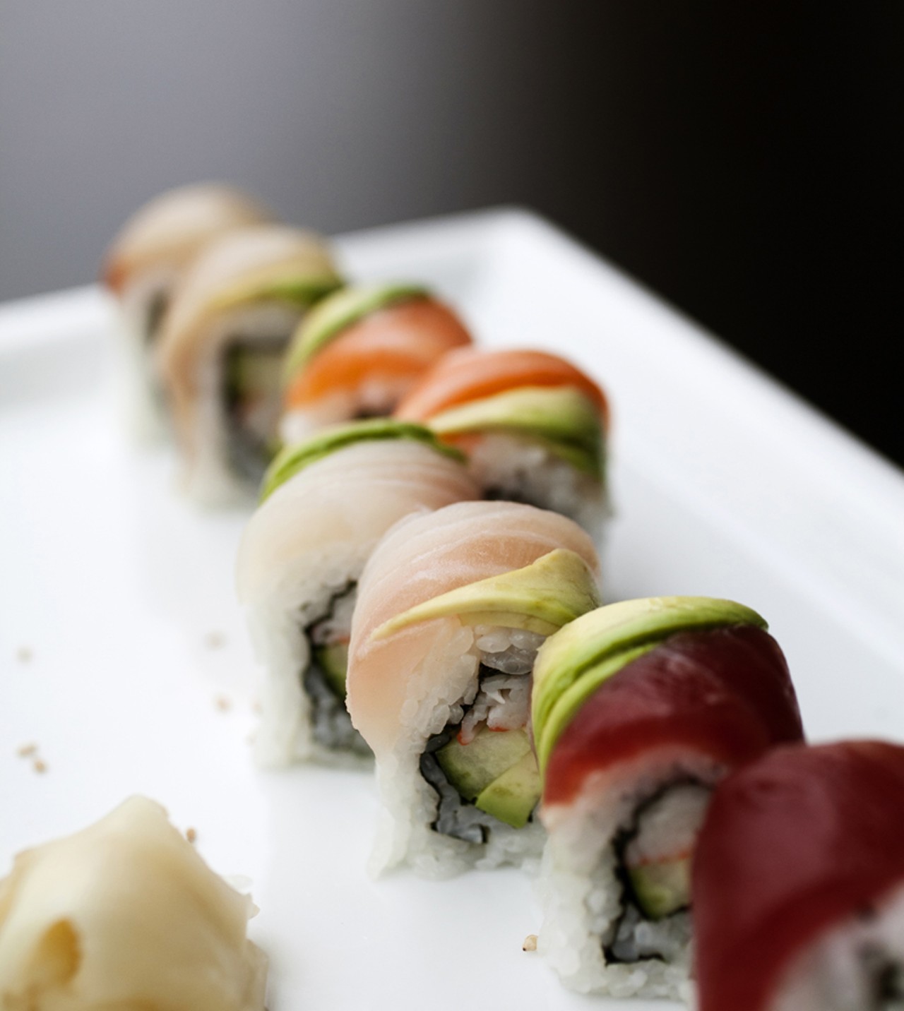Rainbow roll is crab stick with cucumber topped with four kinds of fish and avocado.