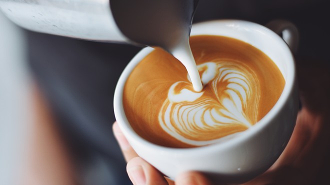 A barista creates latte art.