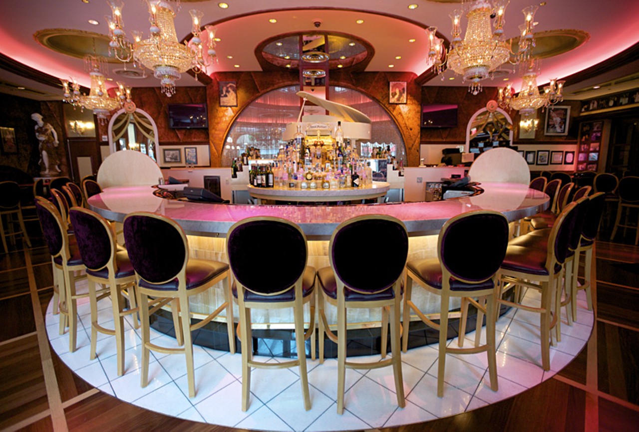 The bar at Jeff Ruby's Steakhouse has a stage above and behind it with the ever-present white piano front and center.