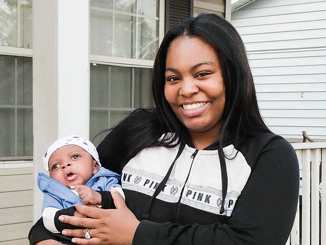 Khorry Ramey, 19, with her newborn son. She is now the same age as her father, Kevin Johnson, when he killed Sgt. William McEntee.