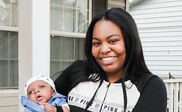 Khorry Ramey, 19, with her newborn son. She is now the same age as her father, Kevin Johnson, when he killed Sgt. William McEntee.