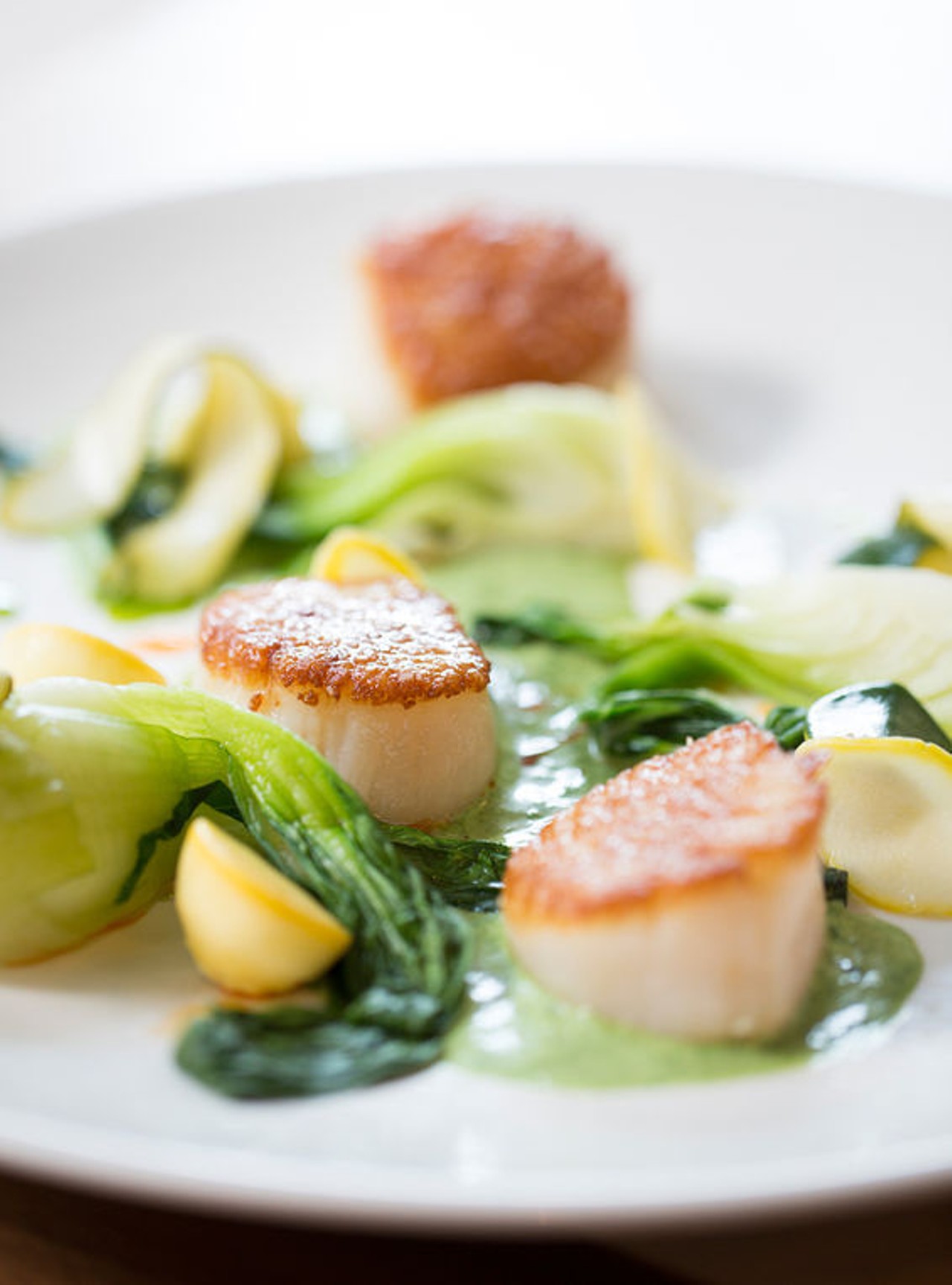 At Central Table Food Hall in the Central West End: An order of scallops comes with summer squash, arugula and bok choy. See more photos from Central Table Food Hall. Photo by Jennifer Silverberg.