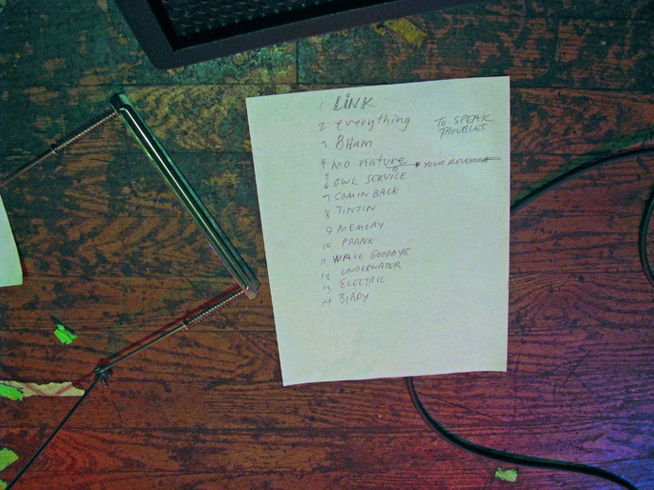 The Stoltz set list next to a harmonica holder.