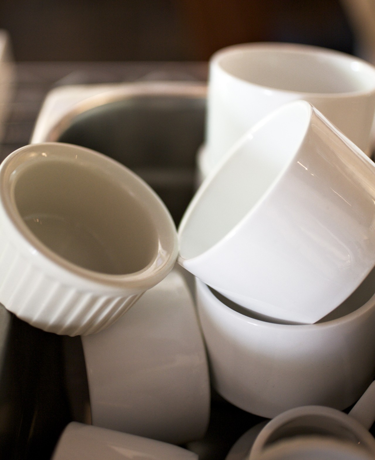Part of the casual appeal, dishes sit on open shelves waiting for use while creating a wall in the main dining room.