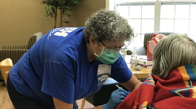 Regina Murdock, a registered nurse with D&H Drugstore, administers a dose of the Pfizer vaccine to a resident on Aug. 6, 2021, at a clinic at the Neighborhoods by TigerPlace in Columbia, Missouri.
