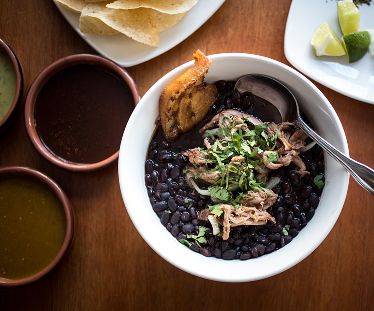 "Asada y Tocino" is a stew of black beans with crispy pork belly, seared beef brisket and onions.