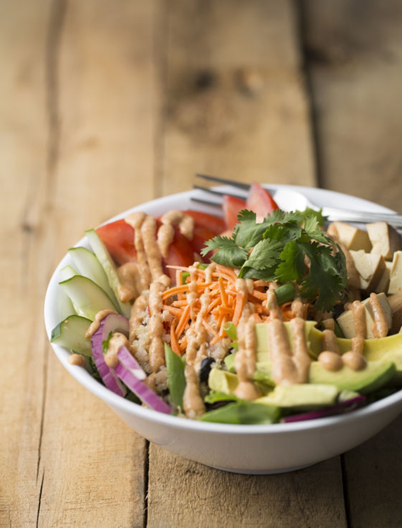 The "Power Protein Bowl" is a quinoa salad with organic marinated tofu, greens, cucumber, red onion, shredded carrot, tomato and fresh avocado with spicy chipotle sauce.