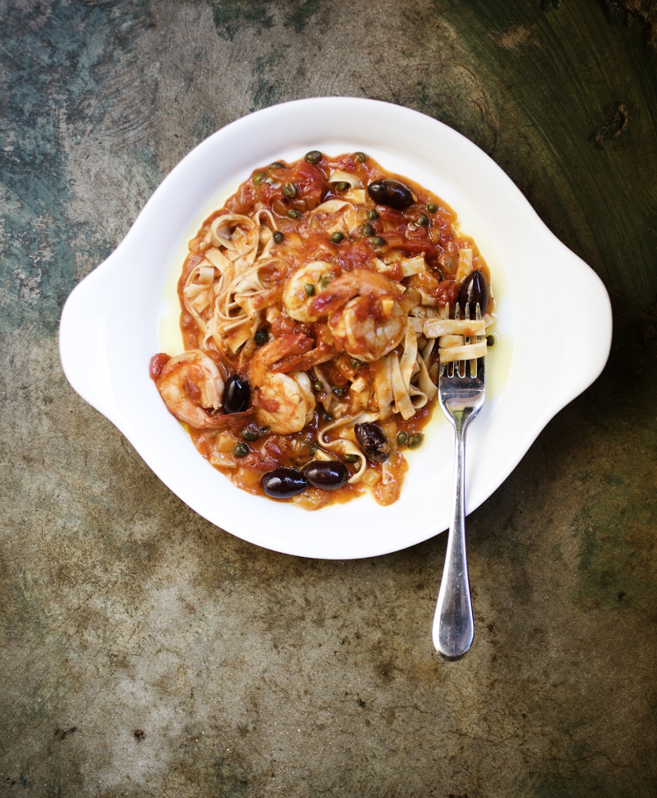 Fettuccine-Gulf Shrimp is served with fresh pasta, olives, capers, basil, chiles and tomato.