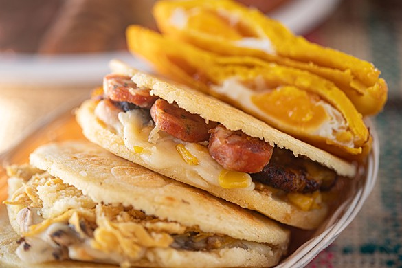 Arepas are available with a variety of fillings, such as a Colombian arepa with sausage, corn, yellow plantain and mozzarella.